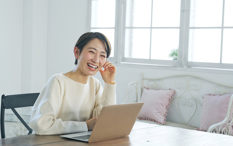 パソコンで作業する笑顔の女性