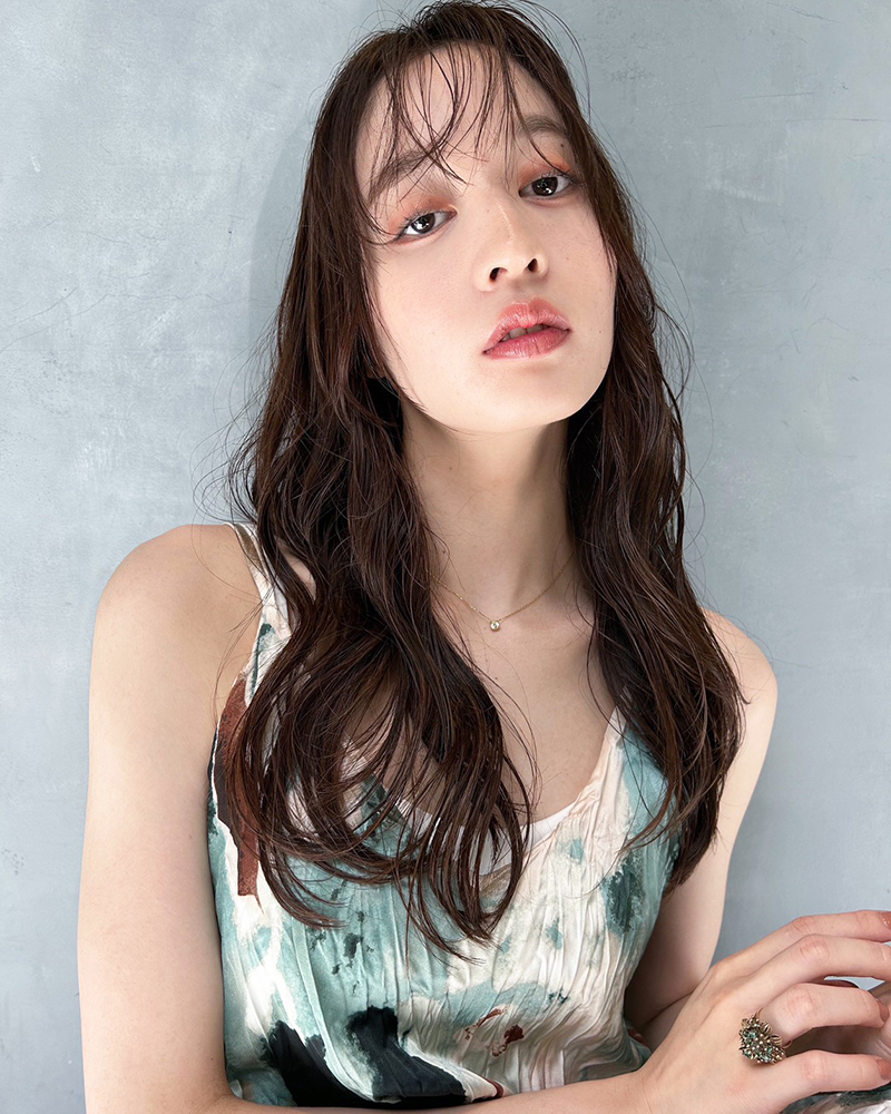 前髪がカールしたウェッティなロングヘアの写真