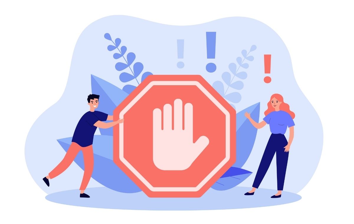 危険を知らせる掌マークのそばに男女が立っているイラスト