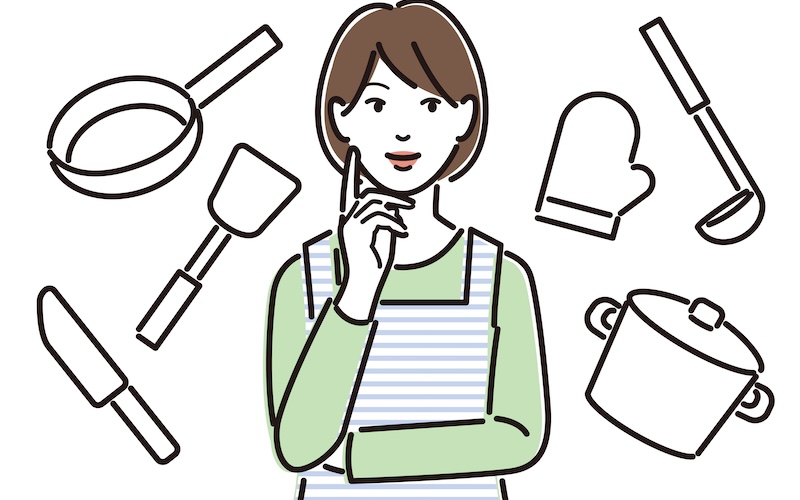 キッチングッズとエプロンをつけた女性のイラスト