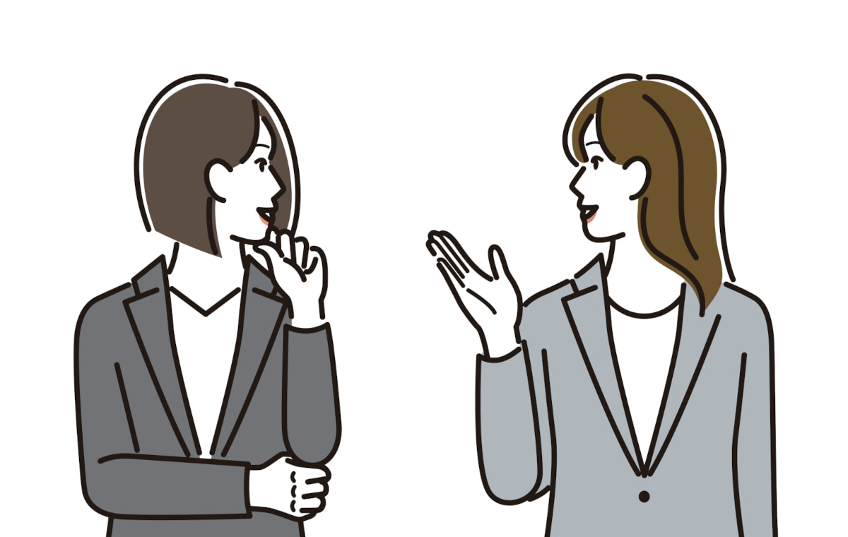 笑顔で会話するスーツ姿の女性二人のイラスト