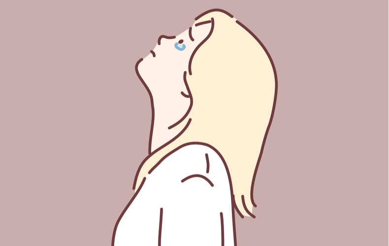 天を見上げて涙をこぼす女性