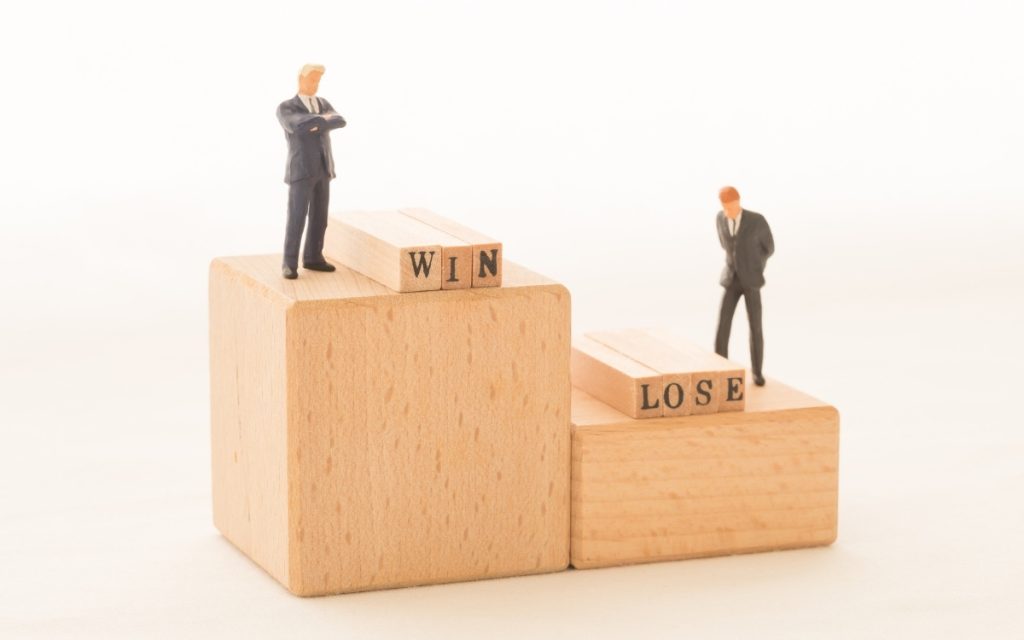 勝者と敗者をフィギュアで表したイメージ