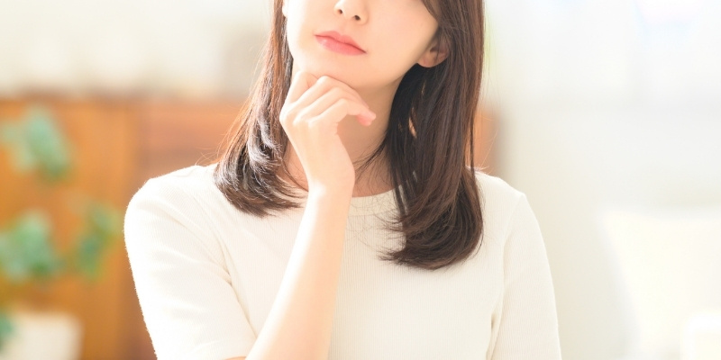 上を向いて考える女性の写真
