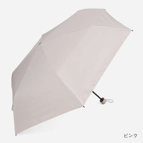 くすみピンクの折り畳み傘を開いた写真